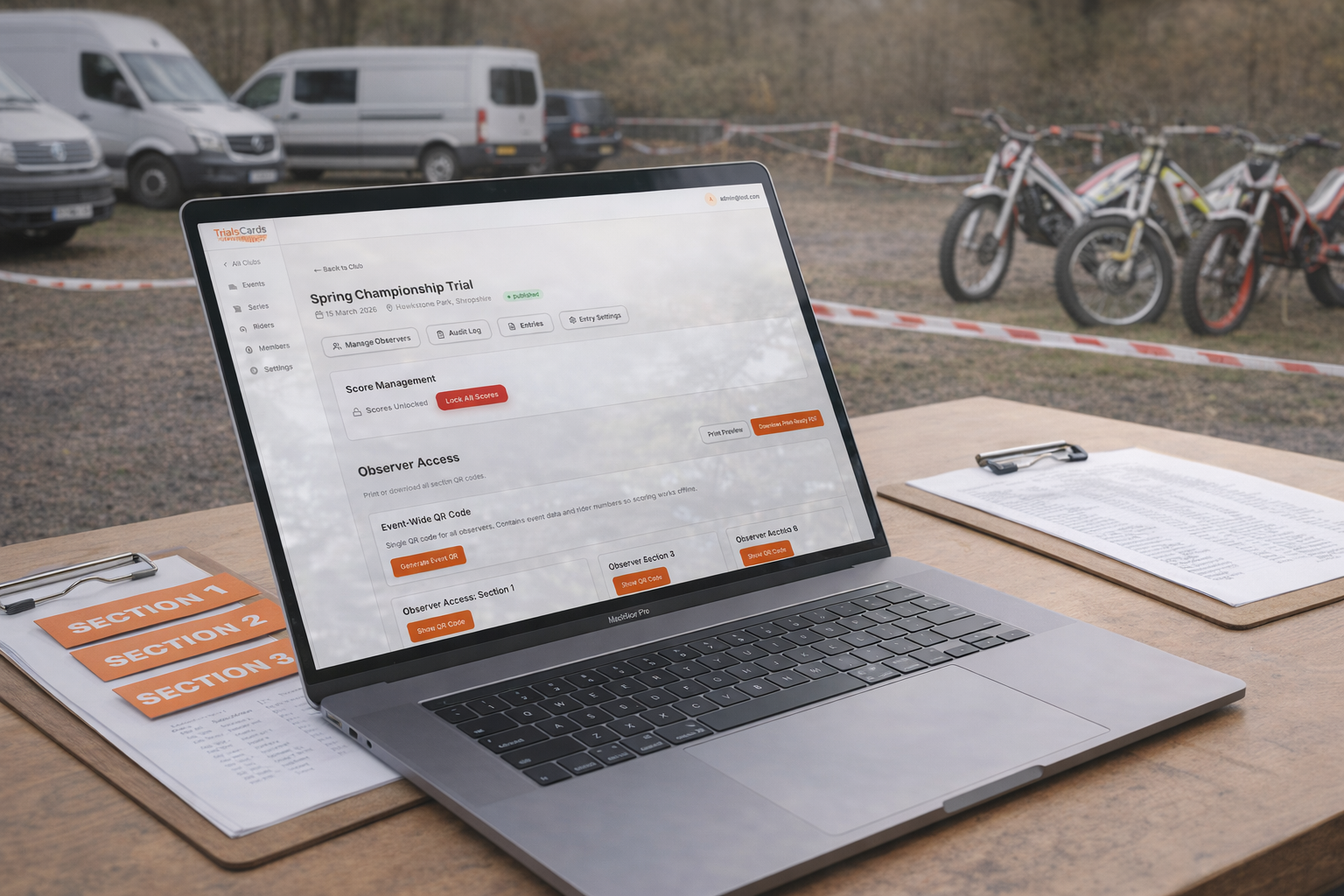 Trials Scorecard event setup shown on a laptop at a UK motorcycle trials paddock sign-on table